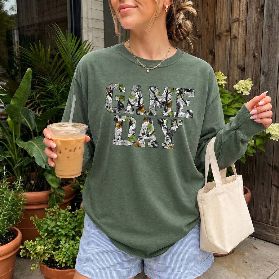 May include a Game Day Camo Print Comfort Colors Unisex Long Sleeve featuring a football-inspired camo print design.