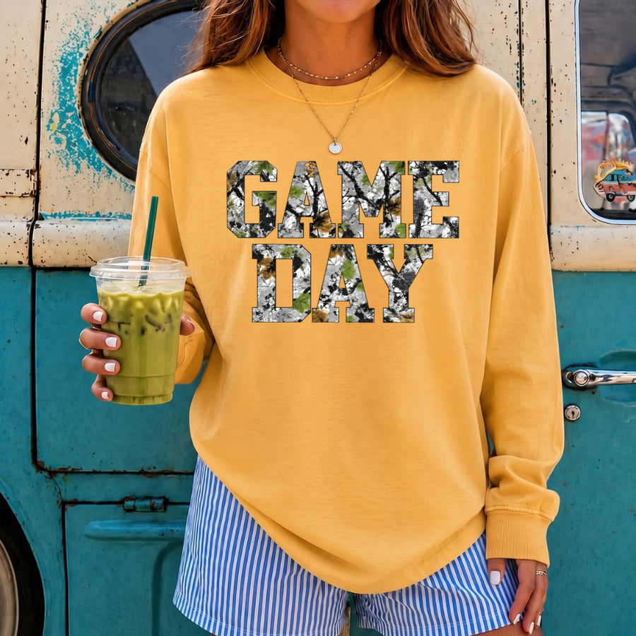 May include a Game Day Camo Print Comfort Colors Unisex Long Sleeve featuring a football-inspired camo print design.