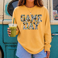 May include a Game Day Camo Print Comfort Colors Unisex Long Sleeve featuring a football-inspired camo print design.