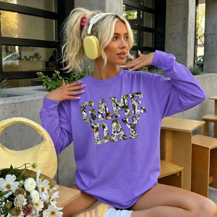May include a Game Day Camo Print Comfort Colors Unisex Long Sleeve featuring a football-inspired camo print design.