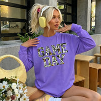 May include a Game Day Camo Print Comfort Colors Unisex Long Sleeve featuring a football-inspired camo print design.
