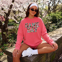 May include a Game Day Camo Print Comfort Colors Unisex Long Sleeve featuring a football-inspired camo print design.