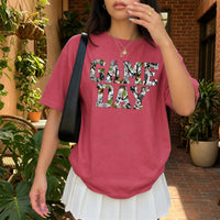 May include a Game Day Comfort Colors Camo Print Football Season Tee featuring a bold camo-inspired game day design.