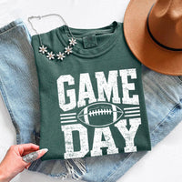 May include a Comfort Colors T-shirt featuring a distressed Game Day graphic with a football design, perfect for football fans, tailgates, watch parties, and sporting events.