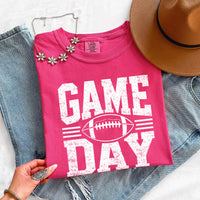 May include a Comfort Colors T-shirt featuring a distressed Game Day graphic with a football design, perfect for football fans, tailgates, watch parties, and sporting events.