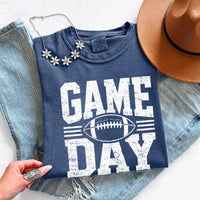 May include a Comfort Colors T-shirt featuring a distressed Game Day graphic with a football design, perfect for football fans, tailgates, watch parties, and sporting events.