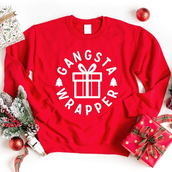 May include a red Christmas sweatshirt with a festive “Gangsta Wrapper” graphic featuring holiday icons and humorous design elements.