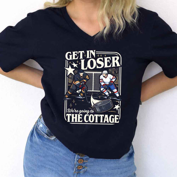 May include Get In Loser, We're Going to the Cottage v-neck tee with hockey romance BookTok graphic and relaxed fit