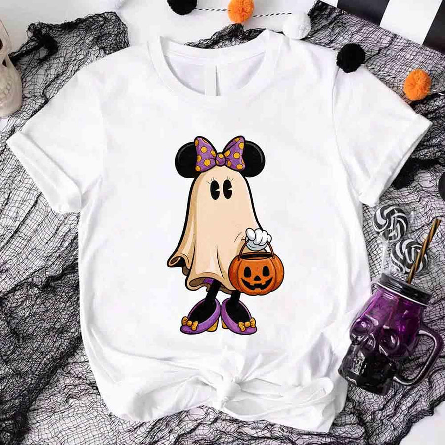 White t-shirt with a ghost character wearing a bow tie and holding a pumpkin, on a Halloween-themed background.