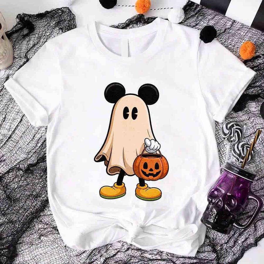 White t-shirt with a ghost character holding a pumpkin bucket on a Halloween-themed background.