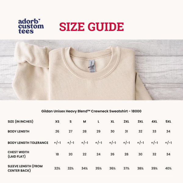 Folded beige sweatshirt with a size guide on a light wooden surface
