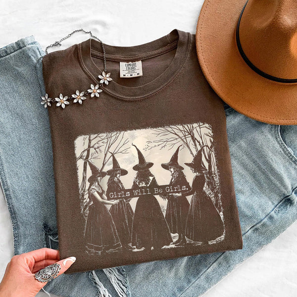 May include Girls Will Be Girls Comfort Colors Halloween t-shirt with festive graphic and relaxed unisex garment-dyed fit