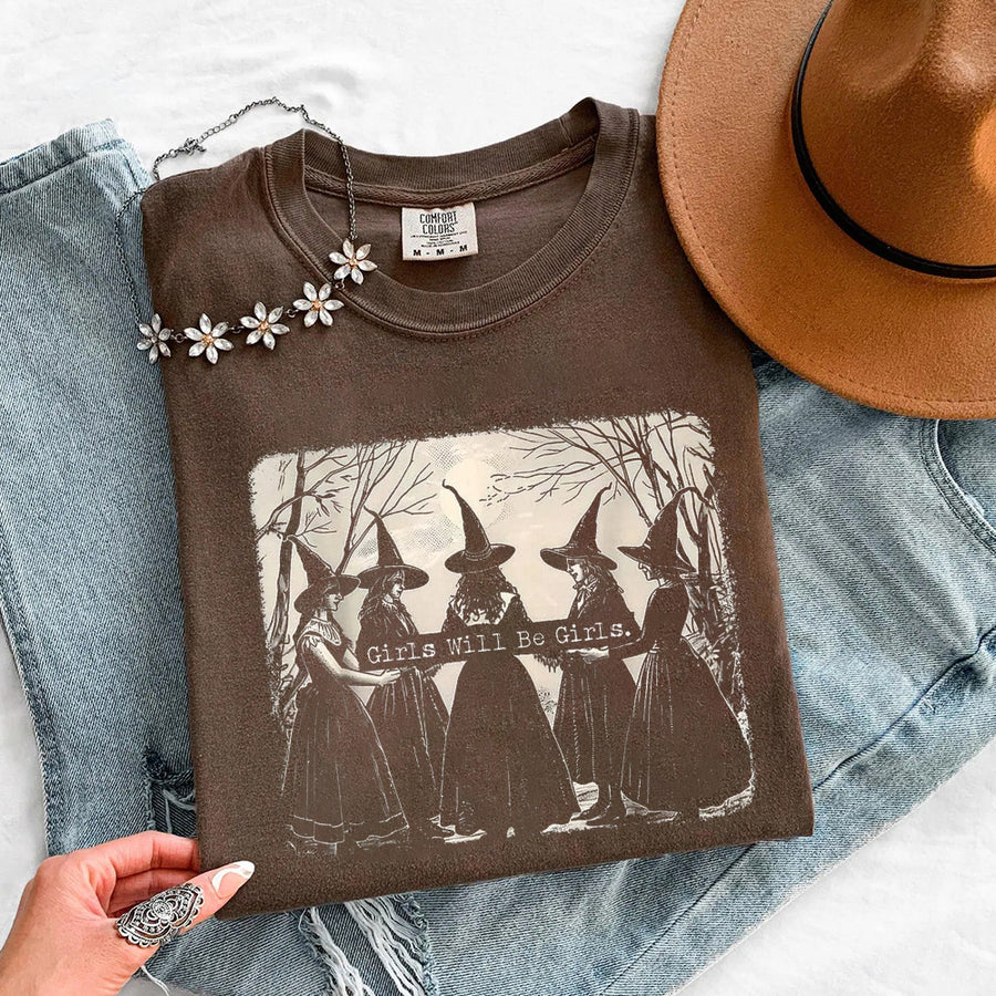 May include Girls Will Be Girls Comfort Colors Halloween t-shirt with festive graphic and relaxed unisex garment-dyed fit