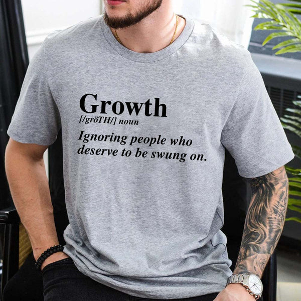 May include a unisex graphic t-shirt featuring the word “Growth” presented as a dictionary-style definition, paired with clean typography and an uplifting message that emphasizes progress, learning, and personal development.