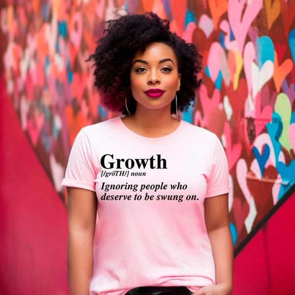 May include a unisex graphic t-shirt featuring the word “Growth” presented as a dictionary-style definition, paired with clean typography and an uplifting message that emphasizes progress, learning, and personal development.