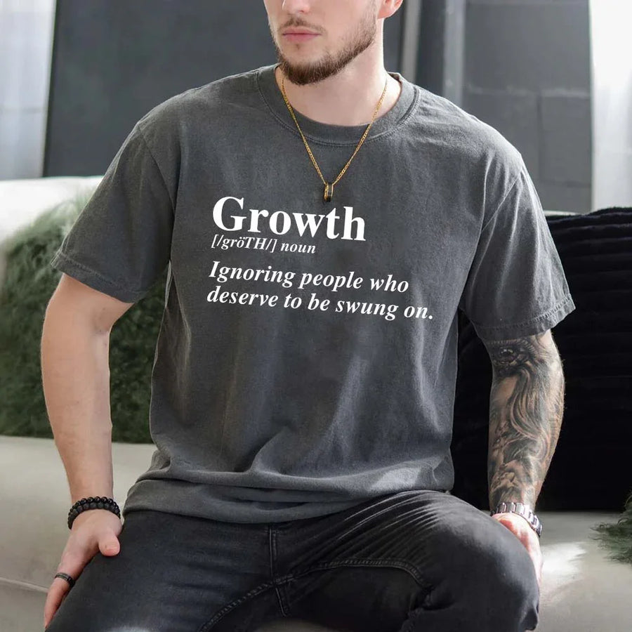 May include a unisex graphic t-shirt featuring the word “Growth” presented as a dictionary-style definition, paired with clean typography and an uplifting message that emphasizes progress, learning, and personal development.
