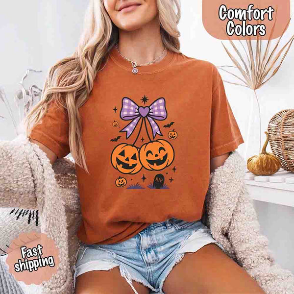 May include Halloween cherries graphic with two jack-o’-lantern pumpkins tied by a purple plaid bow, surrounded by bats, stars, and gravestone – cute spooky shirt design.