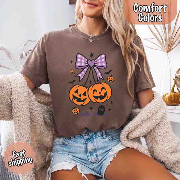 May include Halloween cherries graphic with two jack-o’-lantern pumpkins tied by a purple plaid bow, surrounded by bats, stars, and gravestone – cute spooky shirt design.