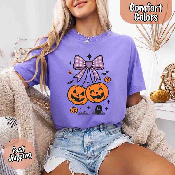 May include Halloween cherries graphic with two jack-o’-lantern pumpkins tied by a purple plaid bow, surrounded by bats, stars, and gravestone – cute spooky shirt design.