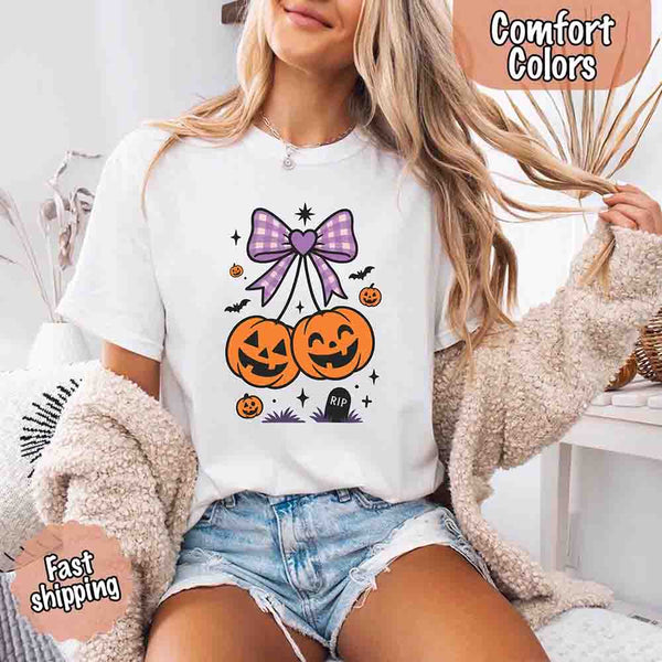 May include Halloween cherries graphic with two jack-o’-lantern pumpkins tied by a purple plaid bow, surrounded by bats, stars, and gravestone – cute spooky shirt design.