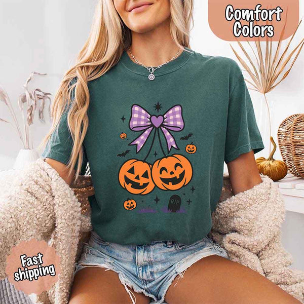 May include Halloween cherries graphic with two jack-o’-lantern pumpkins tied by a purple plaid bow, surrounded by bats, stars, and gravestone – cute spooky shirt design.