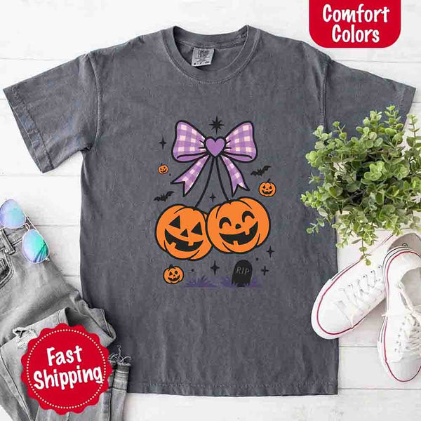 May include Halloween cherries graphic with two jack-o’-lantern pumpkins tied by a purple plaid bow, surrounded by bats, stars, and gravestone – cute spooky shirt design.