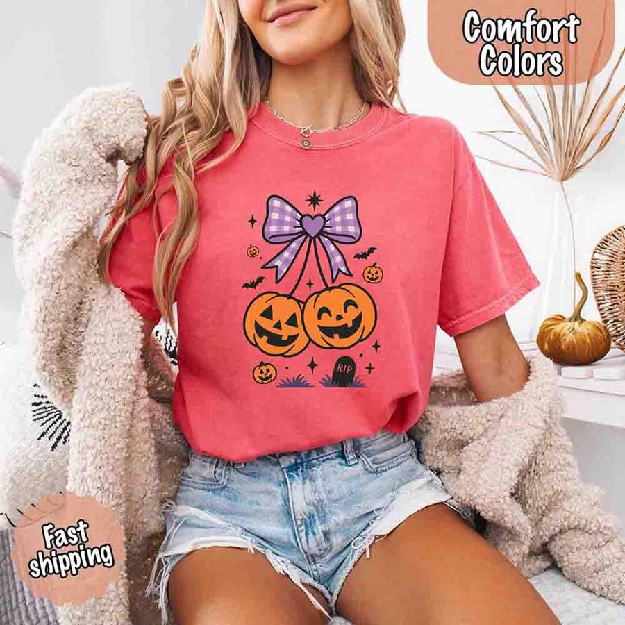 May include Halloween cherries graphic with two jack-o’-lantern pumpkins tied by a purple plaid bow, surrounded by bats, stars, and gravestone – cute spooky shirt design.