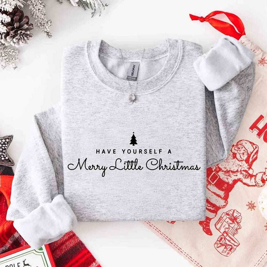 May include a soft unisex crew neck sweatshirt featuring the phrase “Have Yourself a Merry Christmas” in festive print, folded or displayed with warm holiday styling.