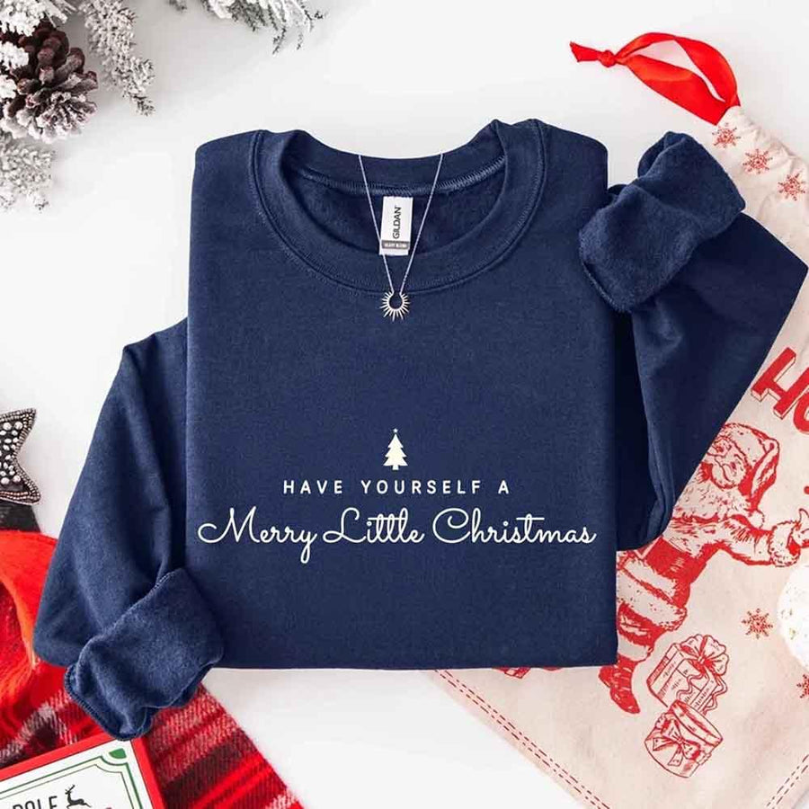 May include a soft unisex crew neck sweatshirt featuring the phrase “Have Yourself a Merry Christmas” in festive print, folded or displayed with warm holiday styling.