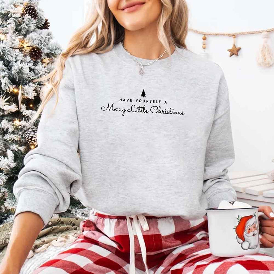 May include a soft unisex crew neck sweatshirt featuring the phrase “Have Yourself a Merry Christmas” in festive print, folded or displayed with warm holiday styling.