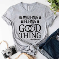 Gray t-shirt with humorous text design on a white surface with accessories.