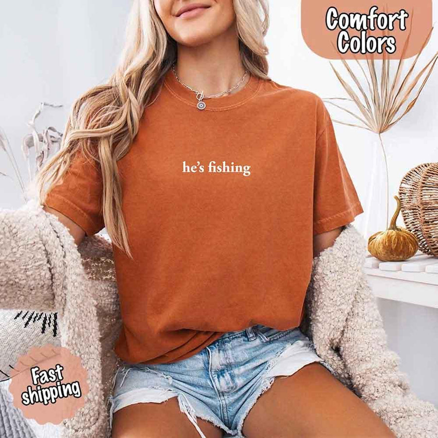 May include a Comfort Colors t-shirt with the phrase 'He’s Fishing' — a funny and laid-back design, ideal for women who enjoy a relaxed fit with humor