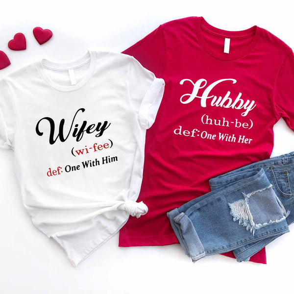 May include matching couple shirts with Hubby and Wifey text definition style, Hubby shirt saying ‘One With Her’ and Wifey shirt saying ‘One With Him’ in black and red font – Christian couple apparel.