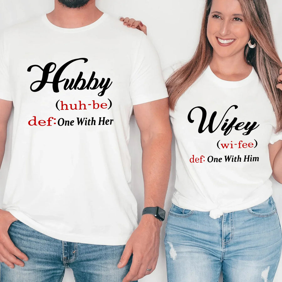 May include matching couple shirts with Hubby and Wifey text definition style, Hubby shirt saying ‘One With Her’ and Wifey shirt saying ‘One With Him’ in black and red font – Christian couple apparel.