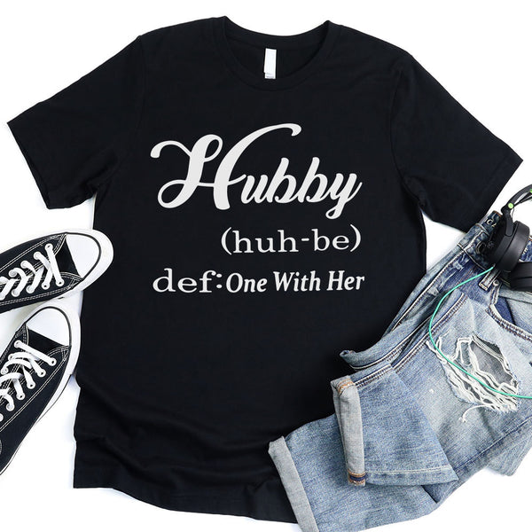 May include Hubby text graphic with definition style design, showing ‘Hubby (huh-be) def: One With Her’ in bold white font – Christian inspirational shirt.