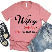 May include Wifey text graphic with definition style design, showing ‘Wifey (wi-fee) def: One With Him’ in black and red font – Christian inspirational shirt.