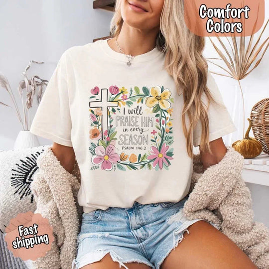 May include bold typography with a floral cross and the phrase “I Will Praise Him in Every Season,” reflecting faith and devotion through every stage of life.