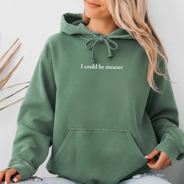Comfort Colors Light Green hoodie with text 'I could be meaner' worn by a person, on a light background.
