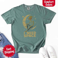 May include a folded black Comfort Colors T-shirt with “i need space” printed in a gothic font, laid over denim jeans for a bold, moody, and alternative vibe.
