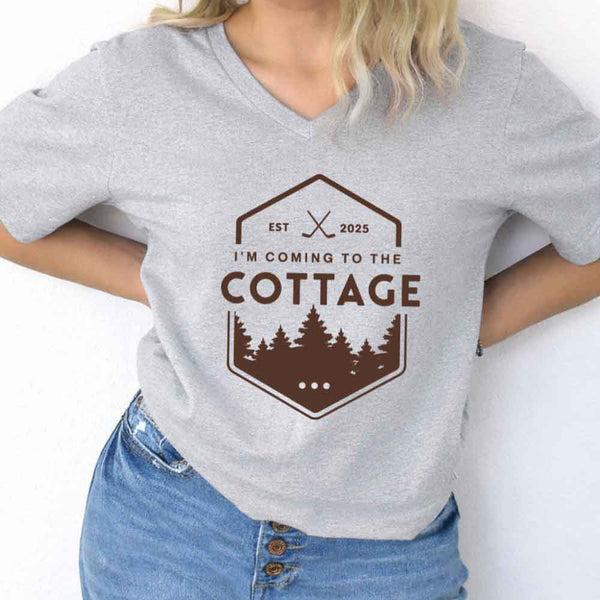 May include I'm Coming to the Cottage v-neck tee with hockey romance BookTok graphic and relaxed unisex fit