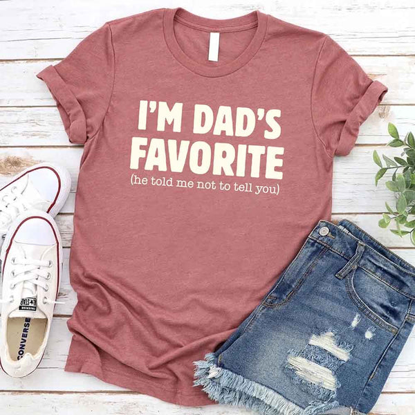 May include a unisex T-shirt with the phrase I’m Dad’s Favorite printed in a bold, humorous style.