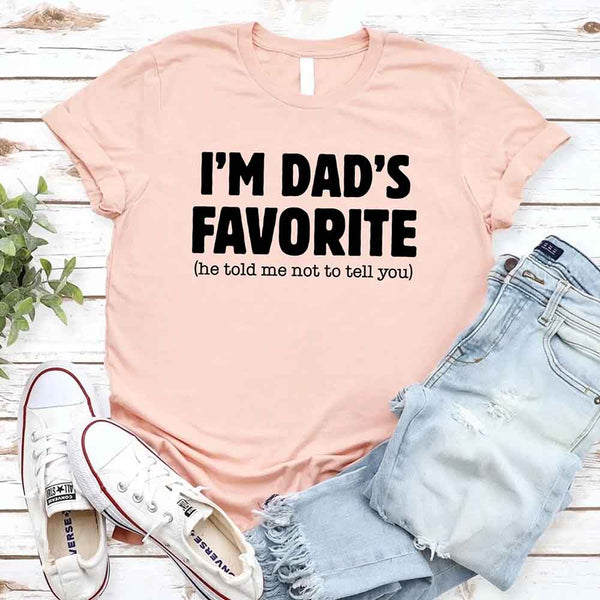 May include a unisex T-shirt with the phrase I’m Dad’s Favorite printed in a bold, humorous style.