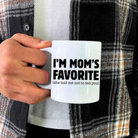 May include a ceramic coffee mug featuring the humorous phrase “I’m Mom’s Favorite” suitable for sons, daughters, and gifting.