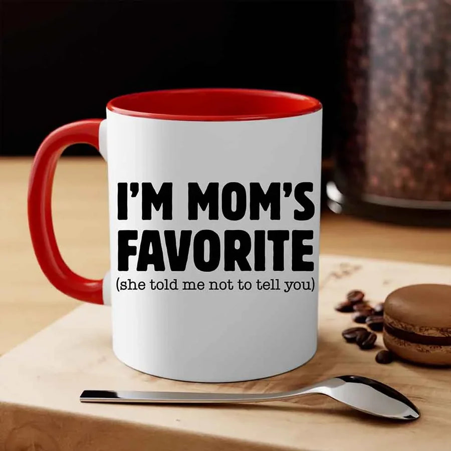 May include a ceramic coffee mug featuring the humorous phrase “I’m Mom’s Favorite” suitable for sons, daughters, and gifting.