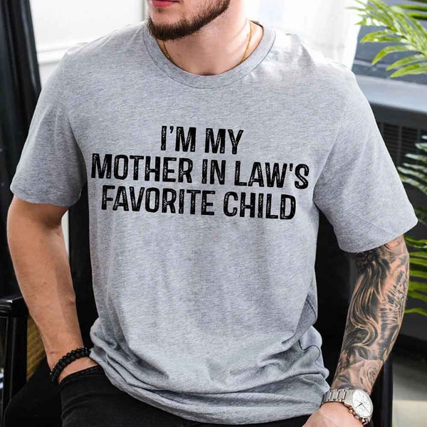 May include a unisex t-shirt printed with the phrase “I’m My Mother-In-Law’s Favorite Child” in a humorous family design.