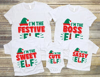 May include a toddler Christmas tee with a playful elf graphic printed on the front, presented on a plain background.