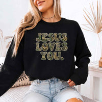 May include Jesus Loves You camouflage sweatshirt with Christian faith graphic design and relaxed unisex fit