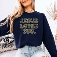 May include Jesus Loves You camouflage sweatshirt with Christian faith graphic design and relaxed unisex fit