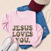 May include Jesus Loves You camouflage sweatshirt with Christian faith graphic design and relaxed unisex fit