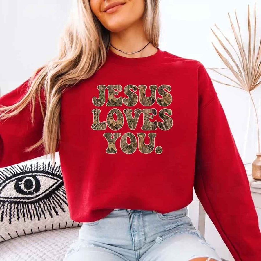 May include Jesus Loves You camouflage sweatshirt with Christian faith graphic design and relaxed unisex fit